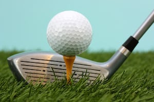 Golf Ball Sitting On A Yellow Tee