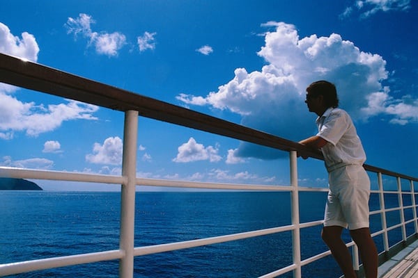 Man Leaning on Cruise Ship Railing